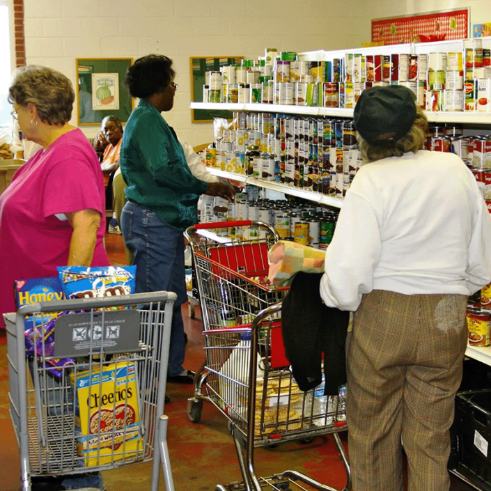 Volunteers packing boxes and assisting feed those in need at the Community Market of East Alabama