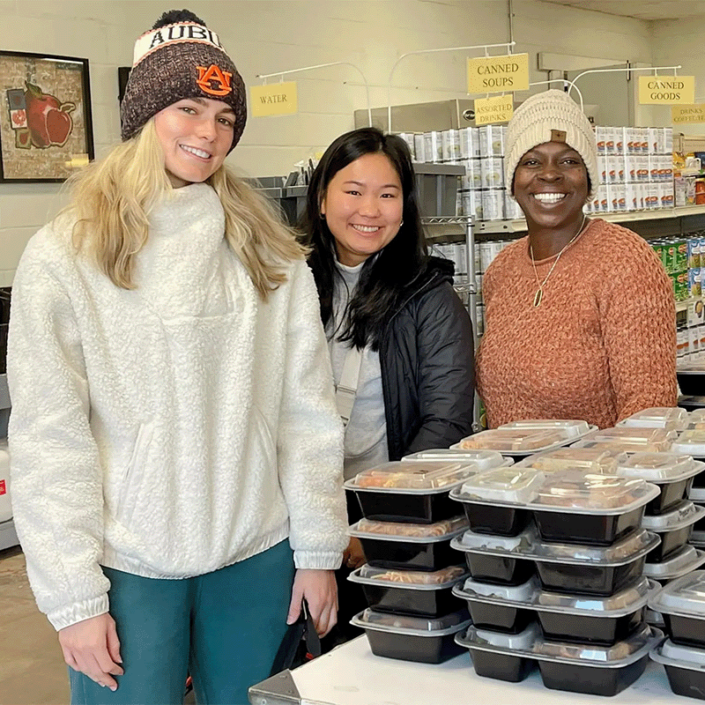 Volunteers packing boxes and assisting feed those in need at the Community Market of East Alabama